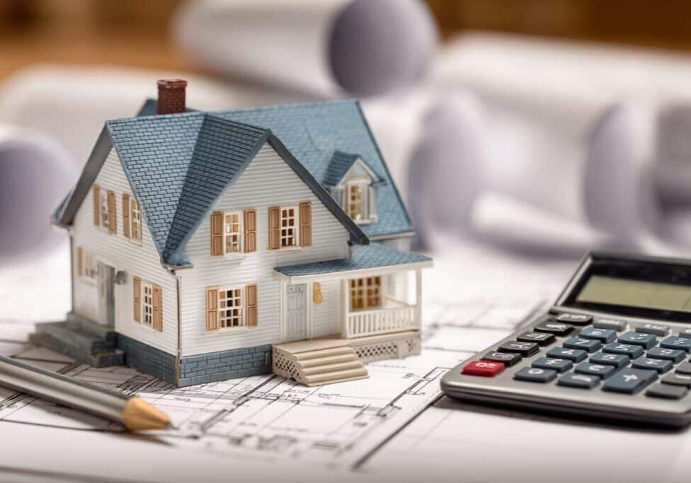 Custom home construction in the Lower Mainland BC with budget planning documents showing cost considerations